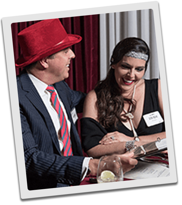 Houston Murder Mystery couple checking out the dinner menu